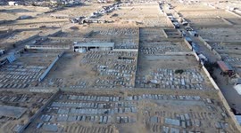 DRONE - Displaced Palestinians shelter among gravestones in Khan Younis cemetery