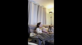 Dog snuggles into baby girl's in adorable family moment