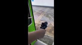 Bus conductor piggybacks passenger through flooded road