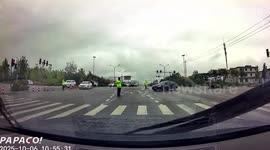 Bungling driver knocks over a traffic policeman in China