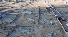 DRONE - Displaced Palestinians shelter among gravestones in Khan Younis cemetery