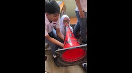 Pupils amuse themselves by using traffic cone as trumpet
