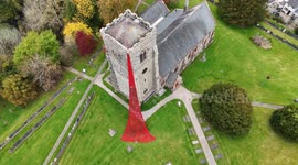 Waterfall of poppies cascade from church tower in Wales ahead of Remembrance Day