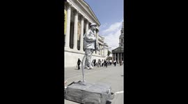 Child Offers Juice to Silverman Statue
