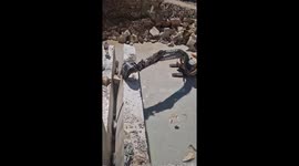 Excavator Knocks Down Travertine Wall