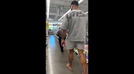 A 6’10” giant walks through a pharmacy looking for a razor — the size contrast turns a simple shopping trip into pure comedy.