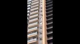 Monkey climbs down tall building in Guangxi, China