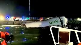 Cargo plant skids off runway and plunges into sea in Hong Kong, killing 2 ground staff