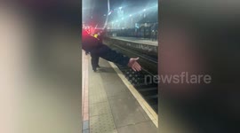 Man 'takes nap' on train tracks before police remove him