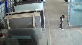 Shocking moment factory worker drops massive pane of glass at a factory