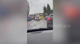 Shocking video shows two teens clinging onto the back of a bus on a busy road