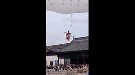 Aerial dancer nearly swept away by wind in Zhejiang, China