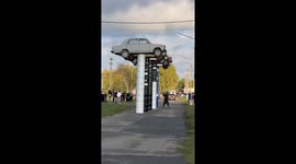 Old Limousine Rams Stacked Barrels With Vintage Soviet Cars on Top