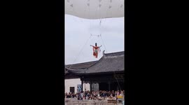 Balloon acrobat crashes into pond during show in China