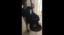 Man plays double bass using an empty bottle in Hebei, China