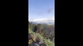 Scenic rainbow appears over colorful autumn foliage in Jackson, New Hampshire, USA
