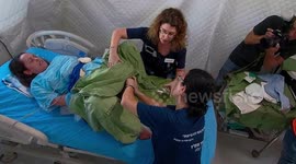 A woman giving birth in field hospital during National Earthquake Drill