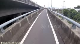 Rug flies off the back of truck into oncoming motorcycle rider
