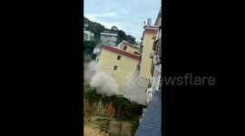 Terrifying moment landslide causes building to slide down hill and collapse in China