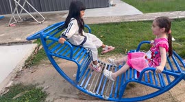 Two little girls having wonderful fun on a roller coaster experience in a local playground.