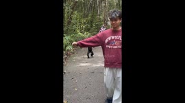 Man interacts with black monkey in Yunnan Province, China