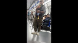 Father playfully taps crying baby’s mouth on train in Beijing, China