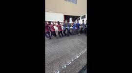 Apprentices carry entire plane from hangar to work on repairs