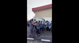 Apprentices carry entire plane from hangar to work on repairs