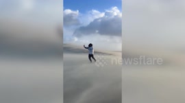 Dramatic moment man battles Storm Benjamin’s winds on Europe's biggest sand dune