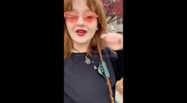 Woman uses hair as leash for service dog—TikTok clip sparks debate on accessibility and creativity