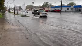 US: Flooded Streets In Erie Turn Road Into Rushing Stream