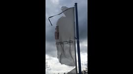 Porsche in trouble – a sign of past success, symbolized by a heavily used and damaged flag trying to withstand the stormy weather. A sign of an economic crisis.