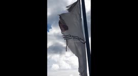 Porsche in trouble – a sign of past success, symbolized by a heavily used and damaged flag trying to withstand the stormy weather. A sign of an economic crisis.