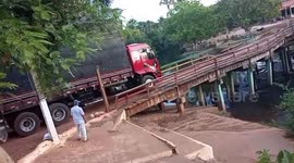 Wooden bridge collapses from weight of truck sending it plunging into river