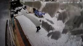 Moment man narrowly escapes being buried by roof snow