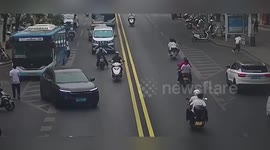 China: Pedestrian Runs Into Motorcyclist Near School In Shiquan