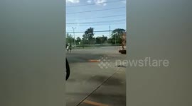 Mother and child flee burning motorcycle at petrol station