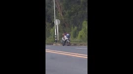 Couple romp on scooter in front of shocked passing drivers