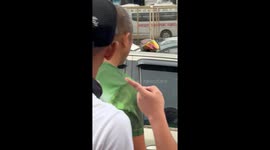 Onlookers smash car window to reach driver stuck inside while suffering heart attack