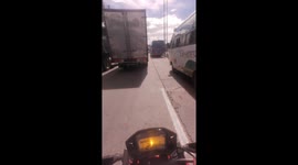 Motorcycle collides with bus on busy road in Soacha, Colombia