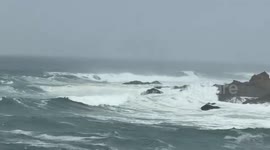 Rough surf crashes against rocky shore in California, USA