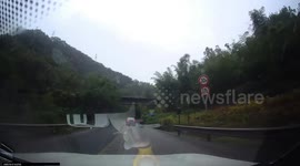Truck collision sends car into roadside canal in Sichuan, China