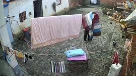 Woman startled as shed roof collapses during laundry in Henan, China