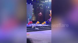 Ultra-realistic robot falls during performance and is left flailing on the floor
