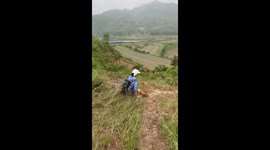 Girl slides down hill and ends up in the grass in Sichuan, China