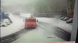 Close call on icy roads as truck slides into parked cars in Kamchatka, Russia