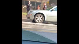 Police Walk Away After Getting Drenched