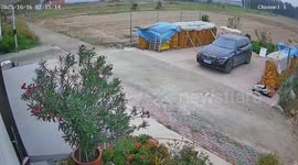 Father stops rolling truck with one hand while holding baby to save his BMW