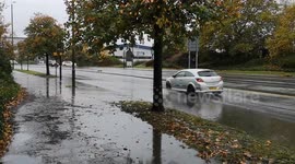 Heavy rain in London causes huge amounts of water to remain on the roads long into the night