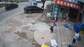 Heroic moment shop owner extinguishes flames on a passing truck